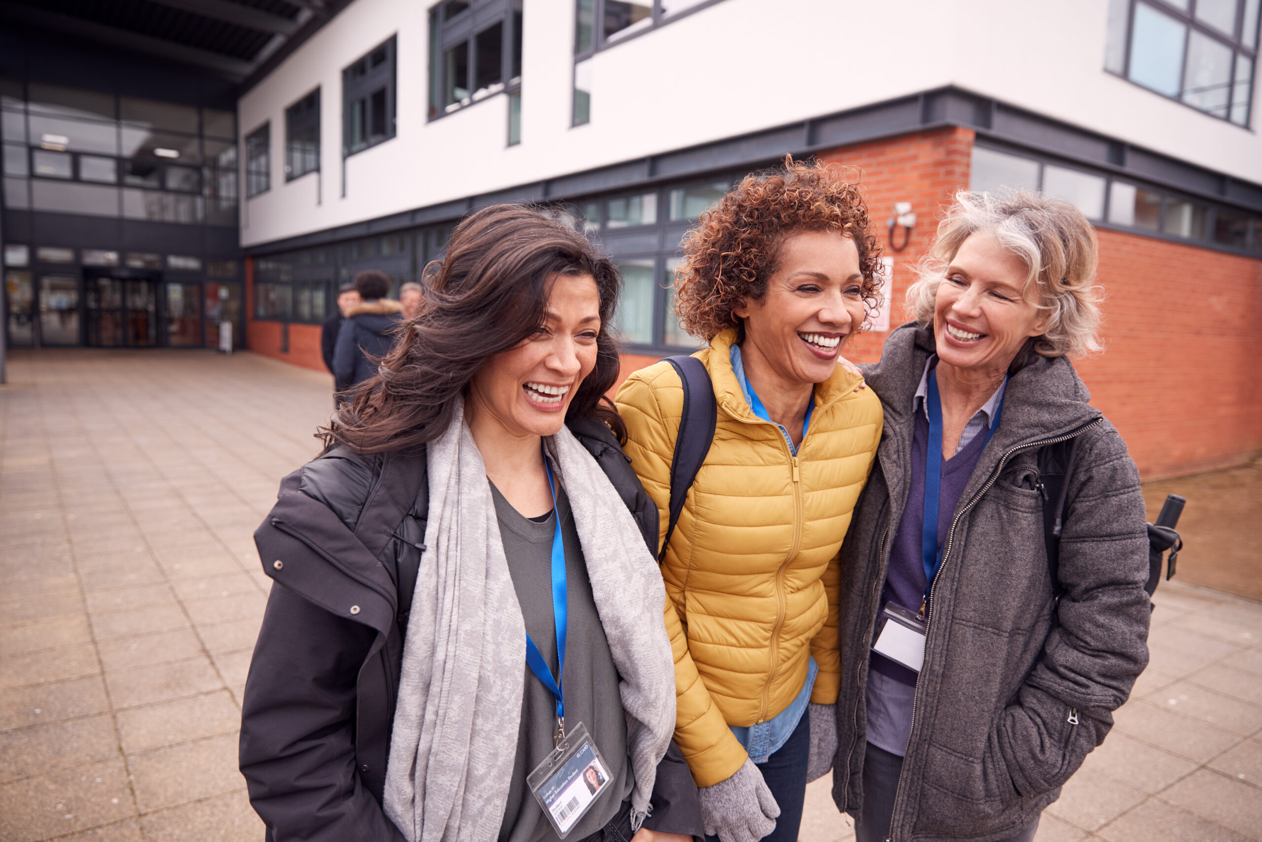group of smiling female walking out of a building