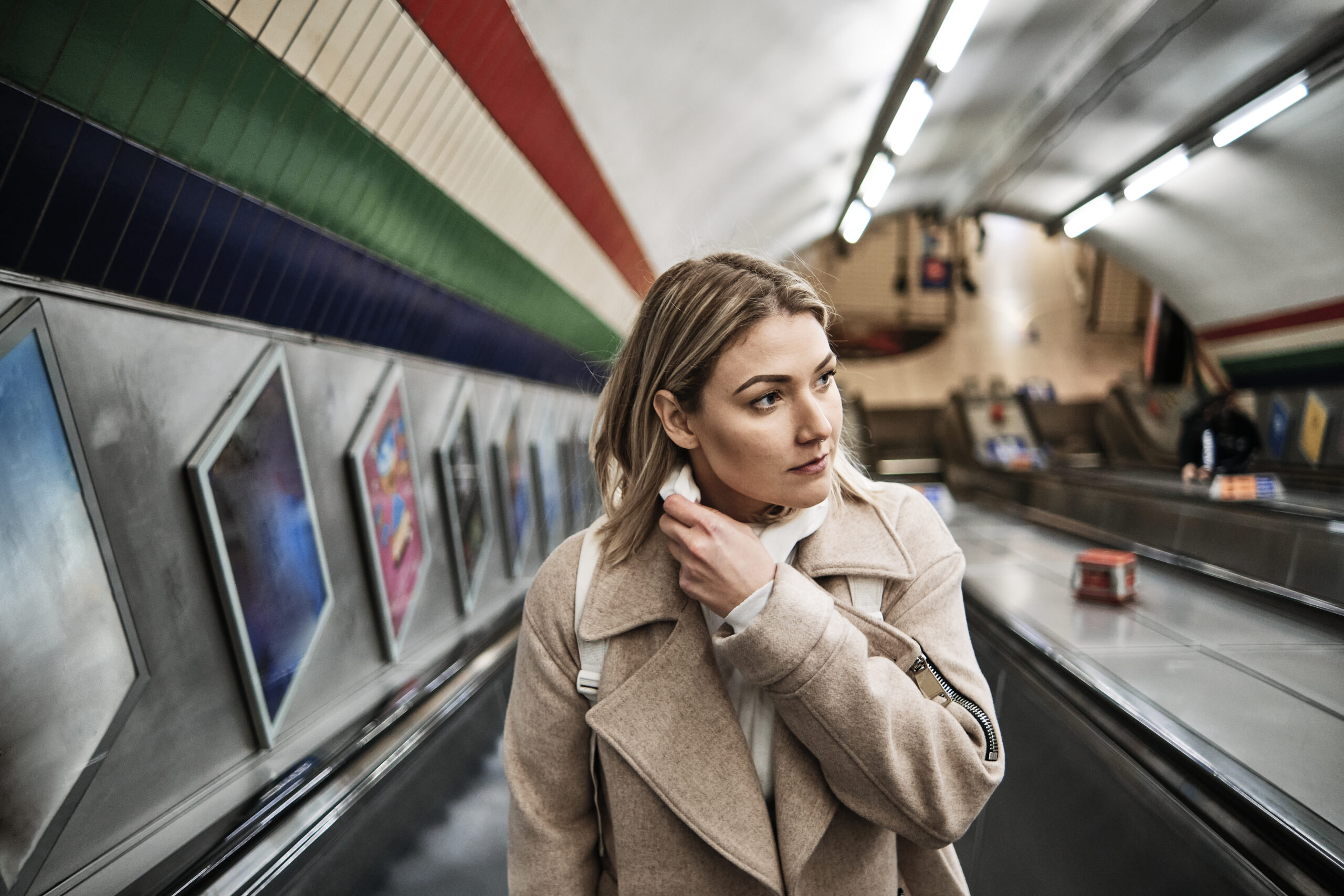 A woman on a tube escalator