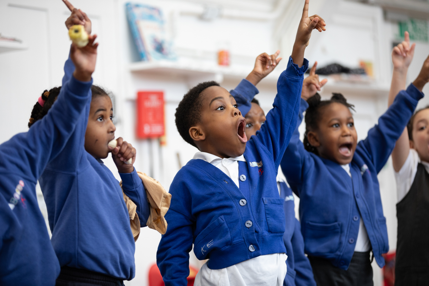 Children in school uniform singing and dancing